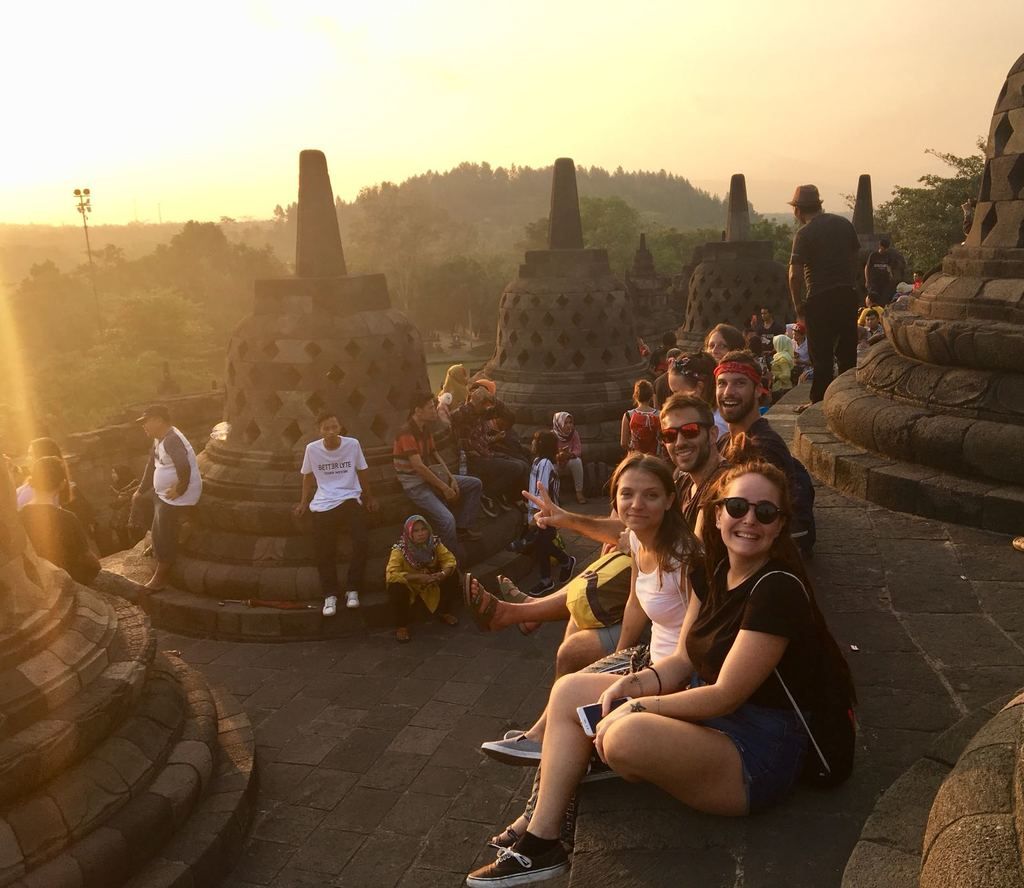 At the Borobudur Temple, a group of guys enjoys the sunset