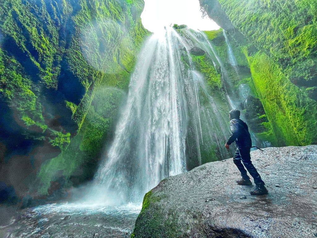 An incredible shot of a WeRoader looking at a waterfall