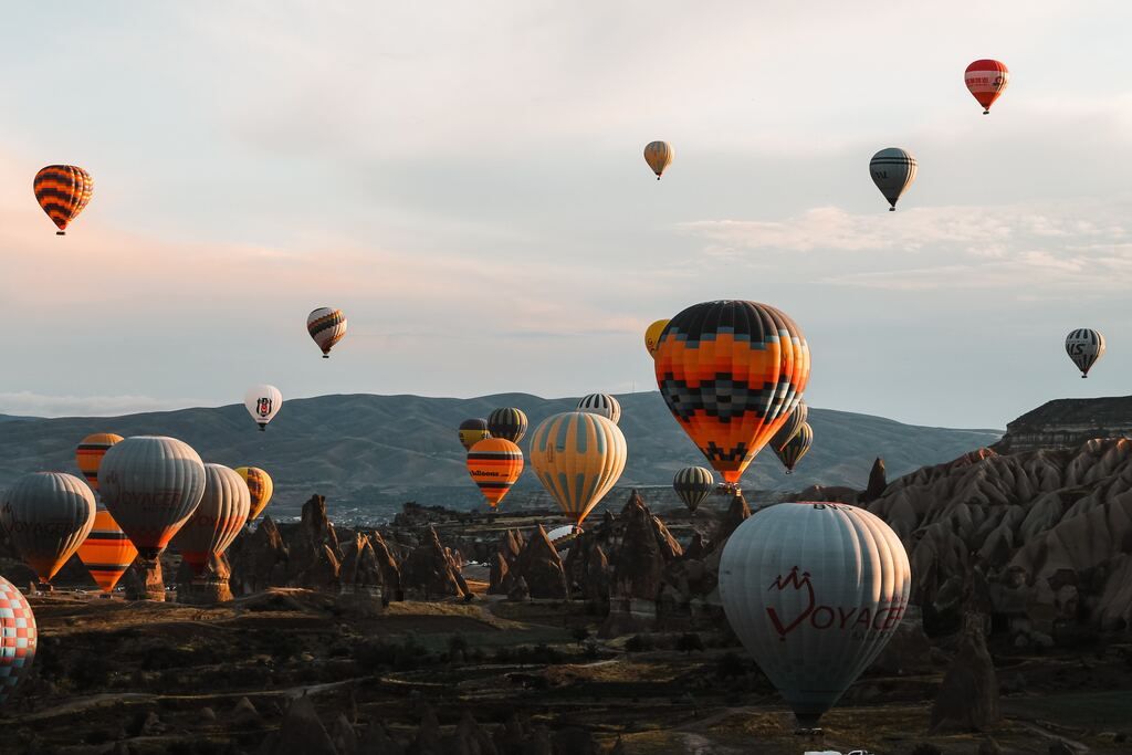 Hot air balloons in assorted colours in Cappadocia.