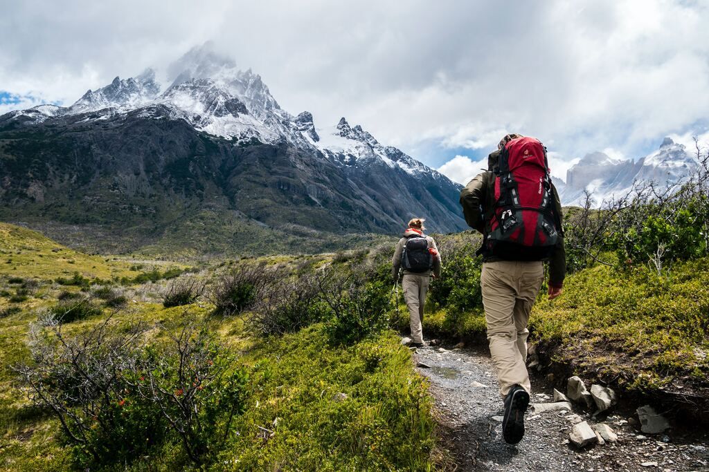 People walking on a road in the Patagonian mountains.