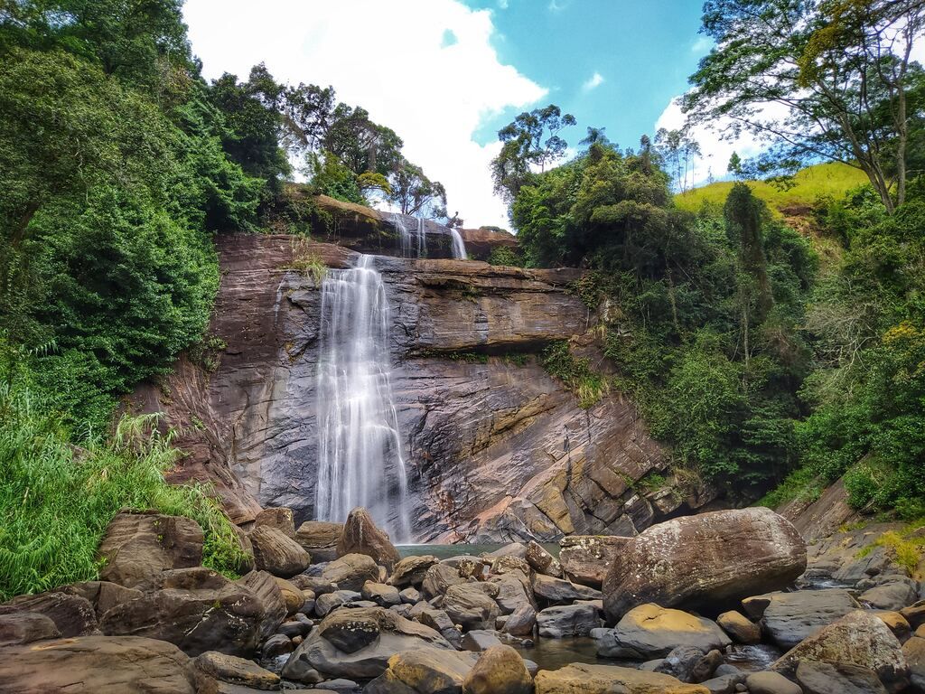 A waterfall with a large amount of water coming out of it in Sri Lanka