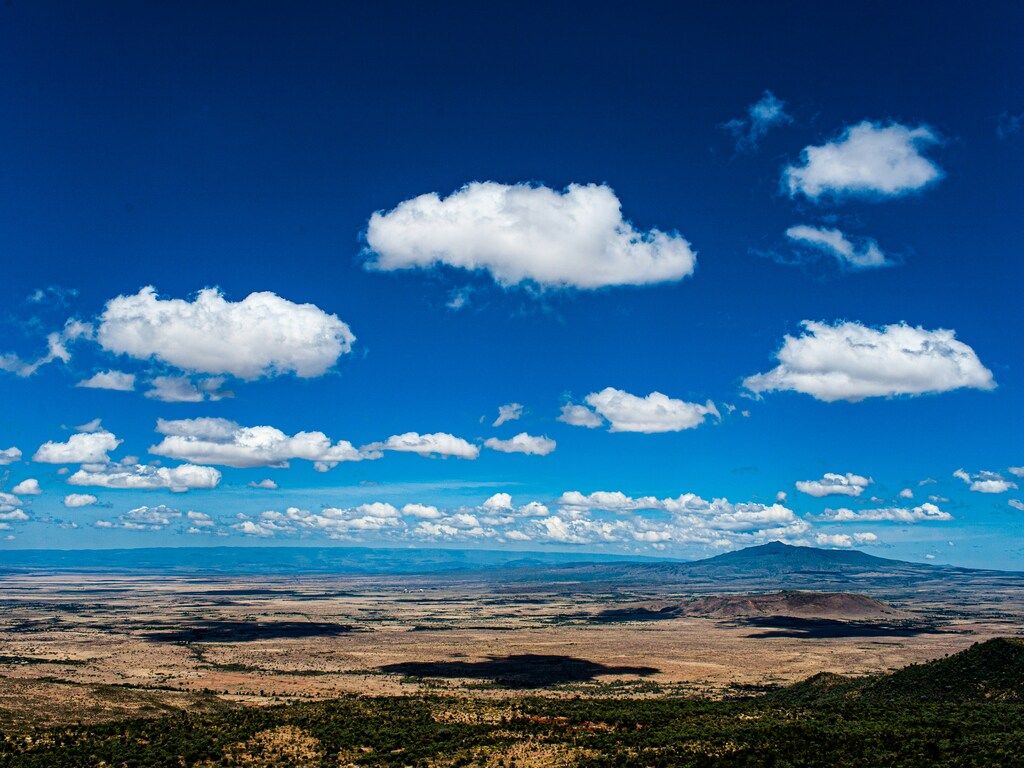 A view of a mountain range with clouds in the sky.