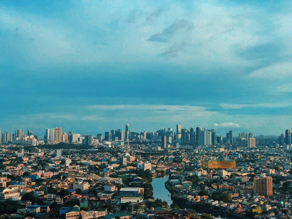 city skyline under blue sky during daytime.