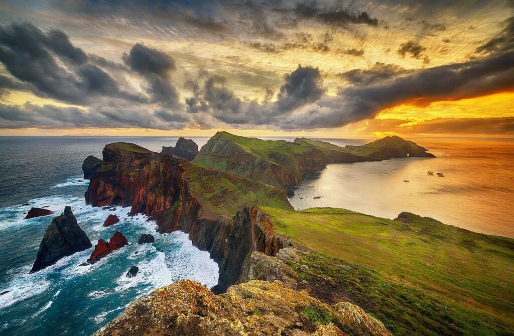 Stunning coastal view of Madeira cliffs with a vibrant sunset, highlighting the natural beauty of the landscape
