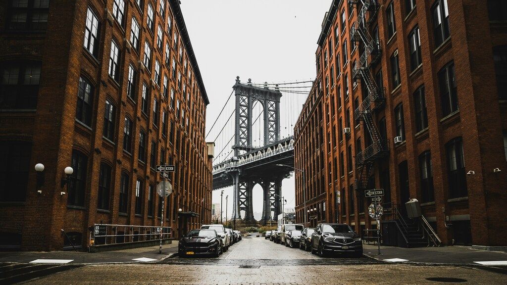 Iconic view of the Manhattan Bridge framed by buildings in New York City