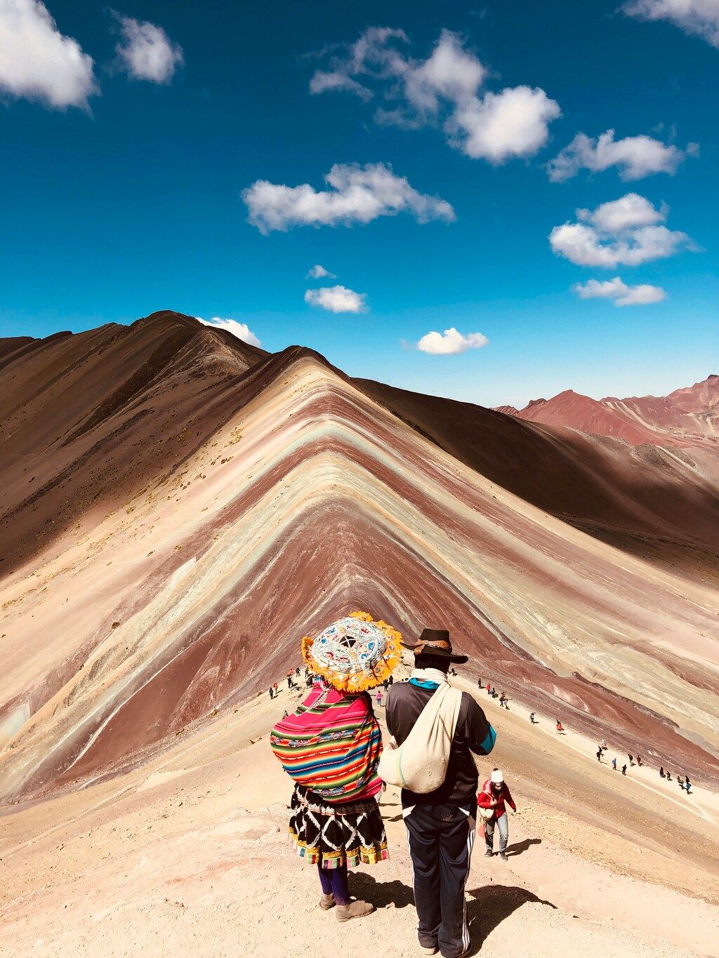 Rainbow Mountain with tourists in traditional clothing, Peru
