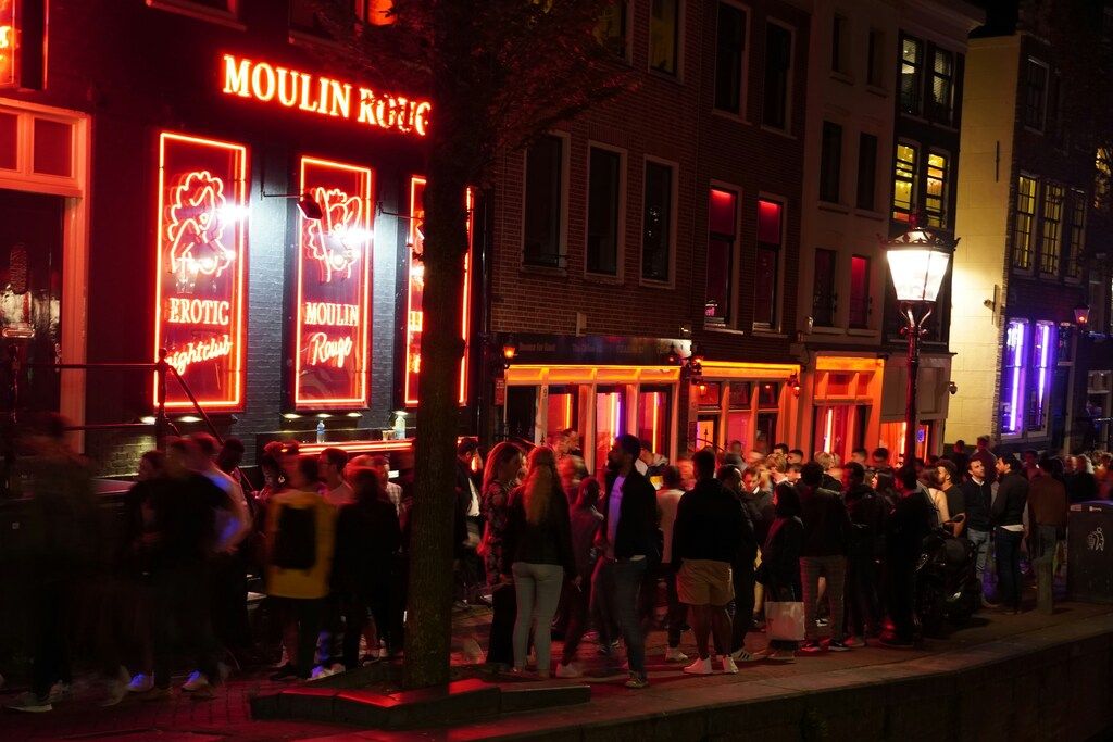 The lively nightlife scene in Amsterdam's red light district with neon signs