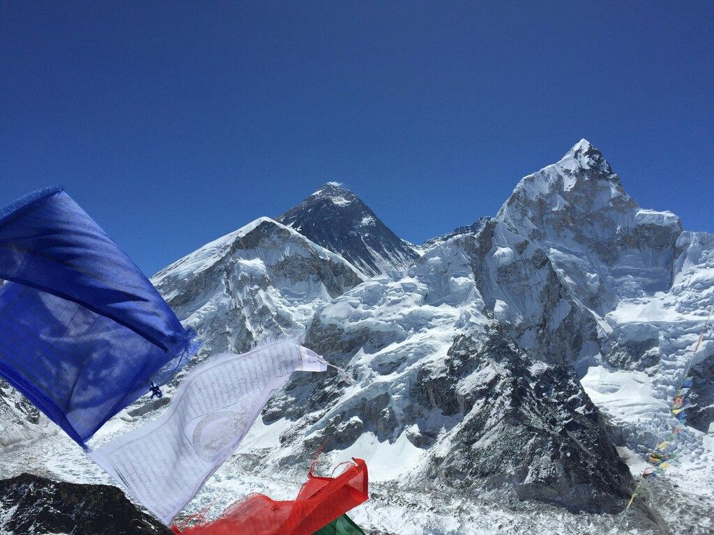 Prayer flags flutter in the wind against the backdrop of the majestic Everest mountain, Nepal