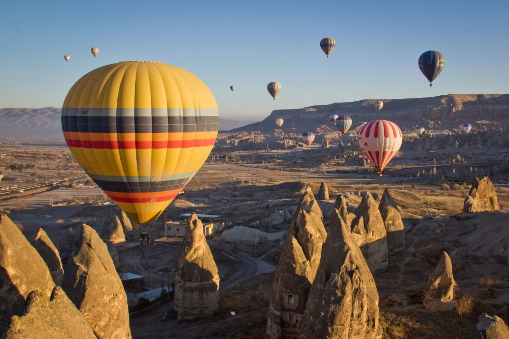 Hot air balloons soaring above the unique rock formations and valleys of Cappadocia Turkey