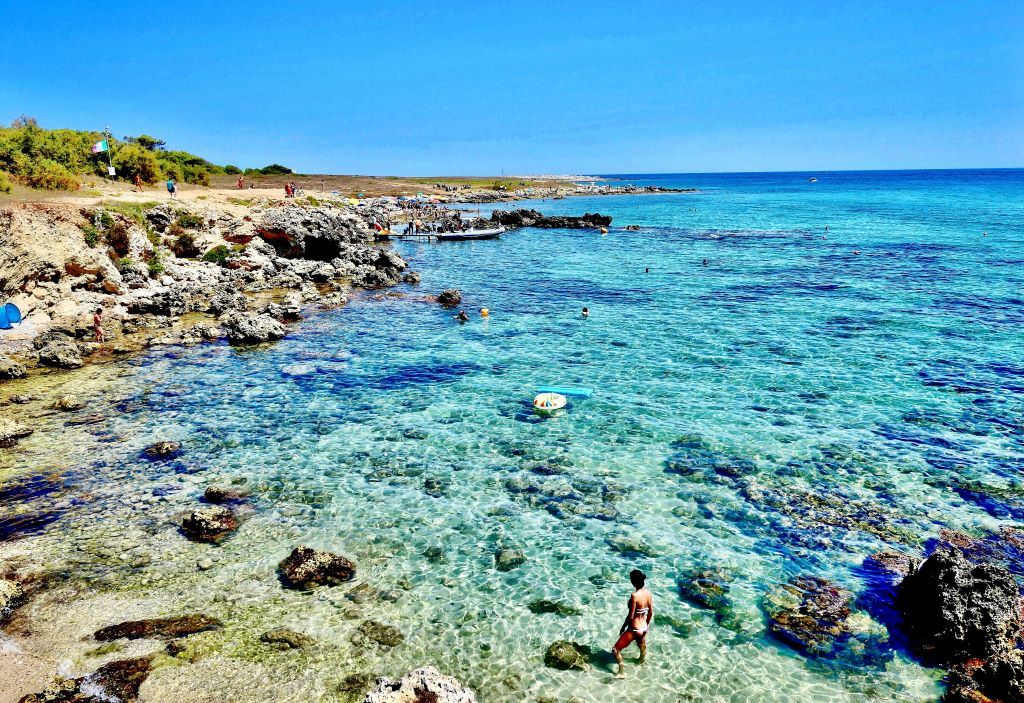 the pristine turquoise waters and the scenic coastal landscape at a rocky beach in Baia dell'Orte, Salento