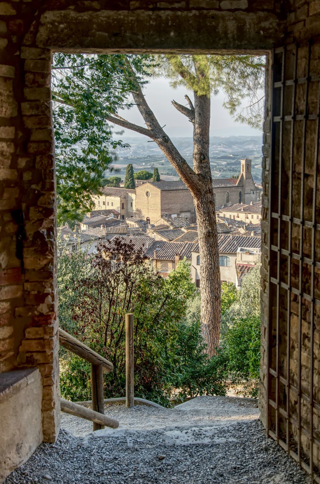 A view through a stone archway of San Gimignano, Siena