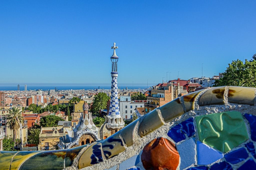 A stunning view of Barcelona from Park Güell, showcasing colorful mosaics and city skyline.