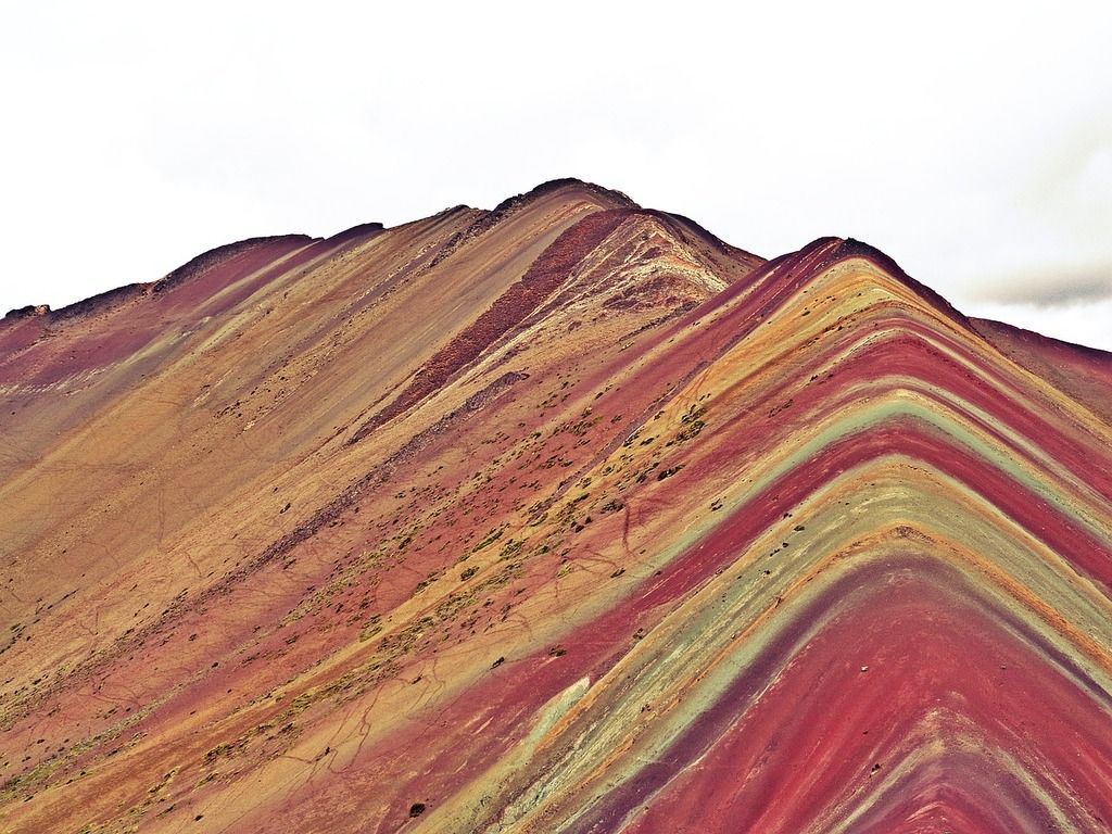 Rainbow Mountain in Peru with colorful layered slopes.