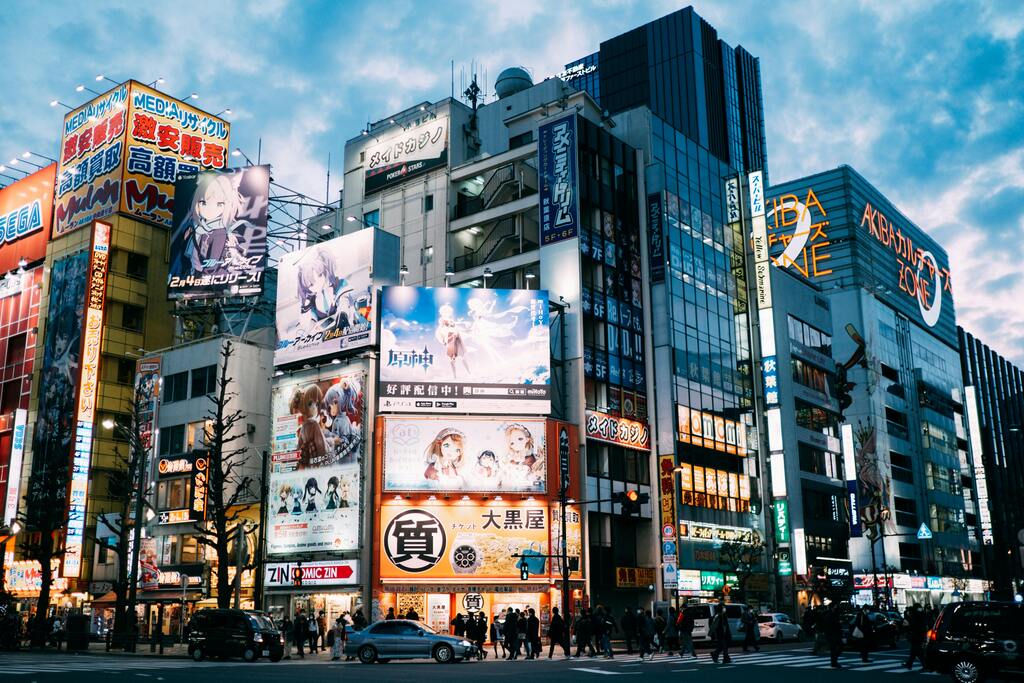 Akihabara district in Tokyo, Japan, featuring colorful billboards and bustling city streets.