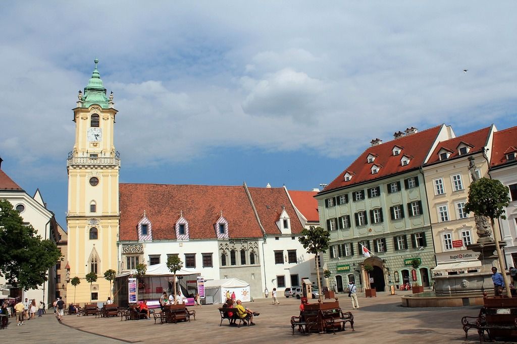 Main square in Bratislava featuring the old town hall and colorful historic buildings under a blue sky