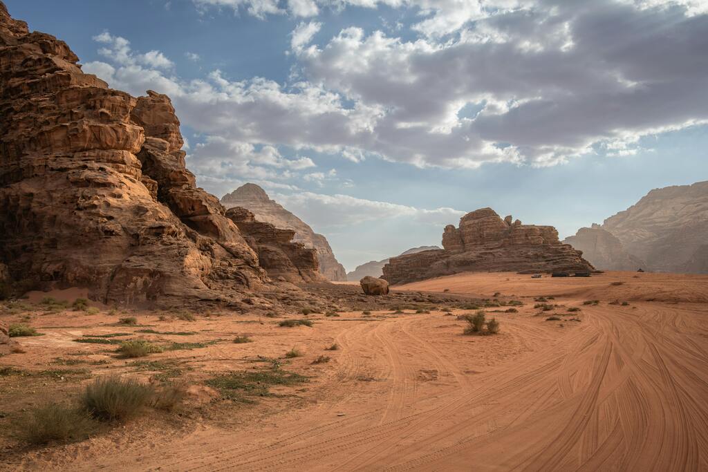 The breathtaking landscape of Wadi Rum desert, Jordan, with its rocky formations and vast sand dunes.