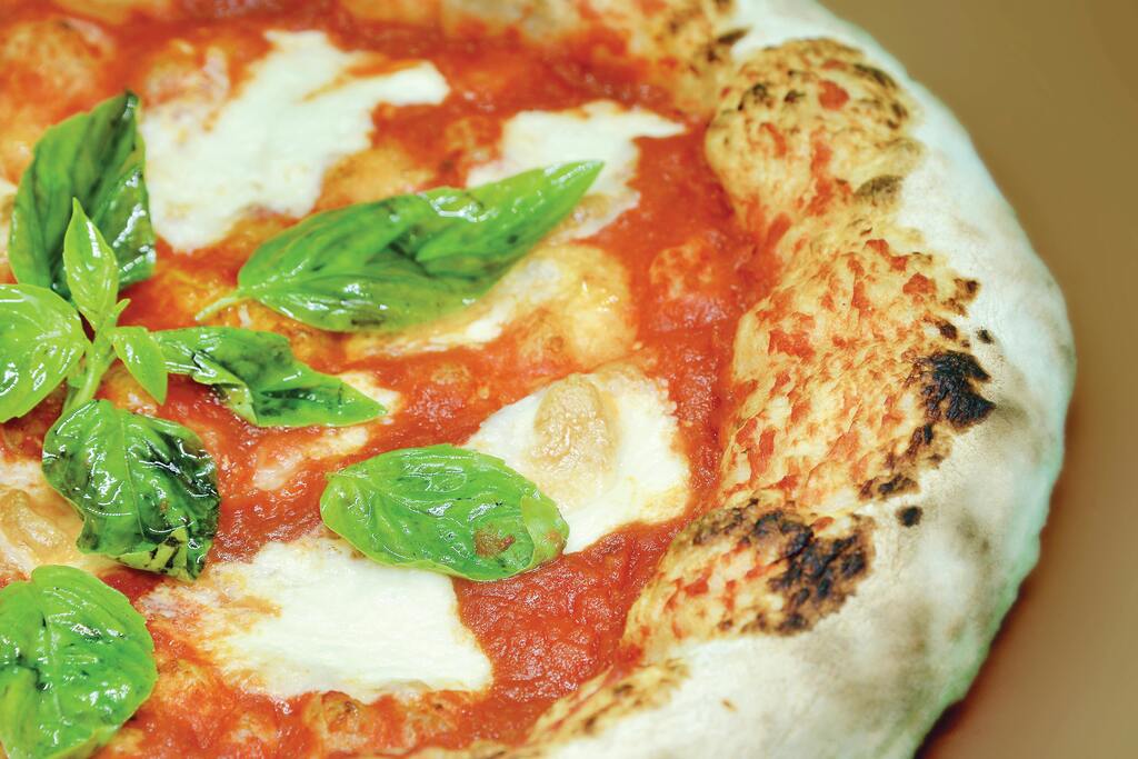 Margherita pizza with fresh basil, mozzarella, and tomato sauce