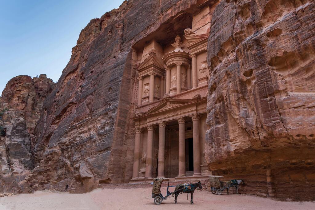 The iconic Al-Khazneh (The Treasury) in Petra, Jordan, carved into the sandstone cliffs.