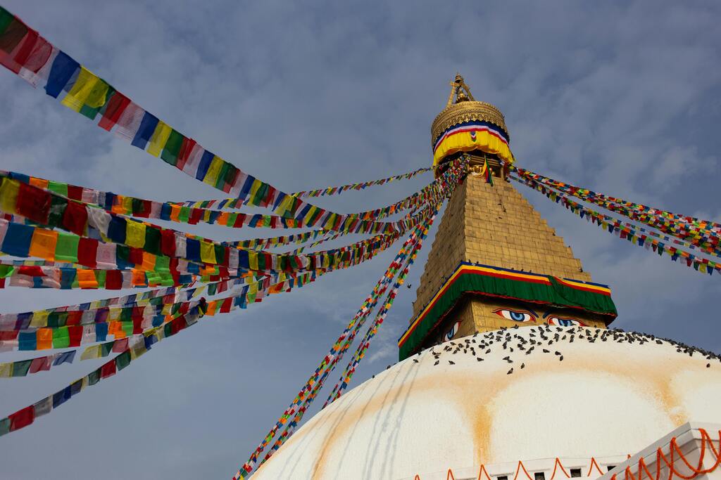 The majestic Boudhanath Stupa adorned with colorful prayer flags in Kathmandu, Nepal.