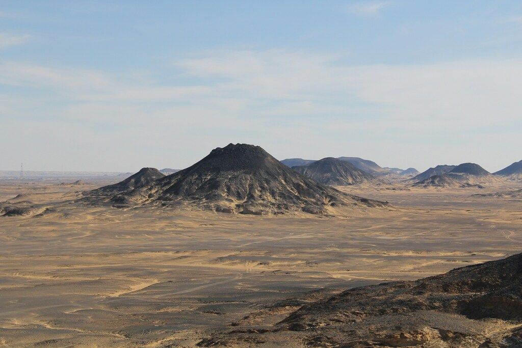 Black Desert mountain landscape in Egypt, with volcanic hills rising from the arid terrain.