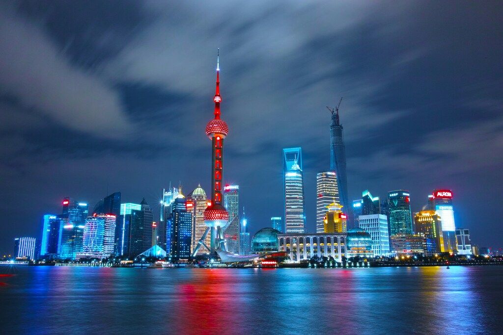 Night view of Shanghai's Pudong skyline with the Oriental Pearl Tower illuminated.