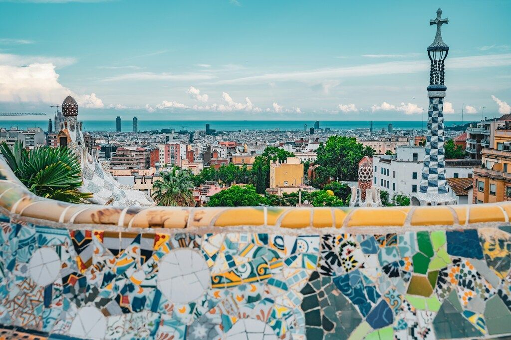 Colorful mosaics and cityscape view from Park Güell in Barcelona