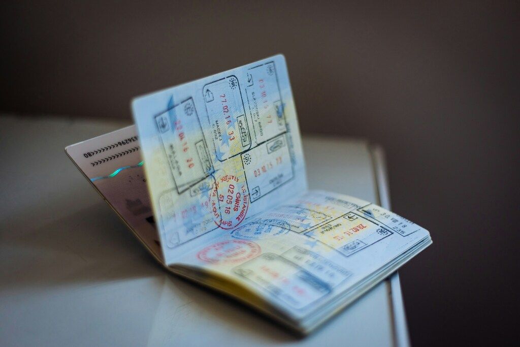 An open passport displaying multiple entry and exit stamps.
