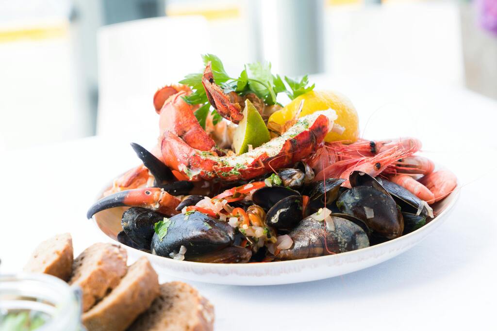 Seafood platter with crab, shrimp, and mussels on a white tablecloth