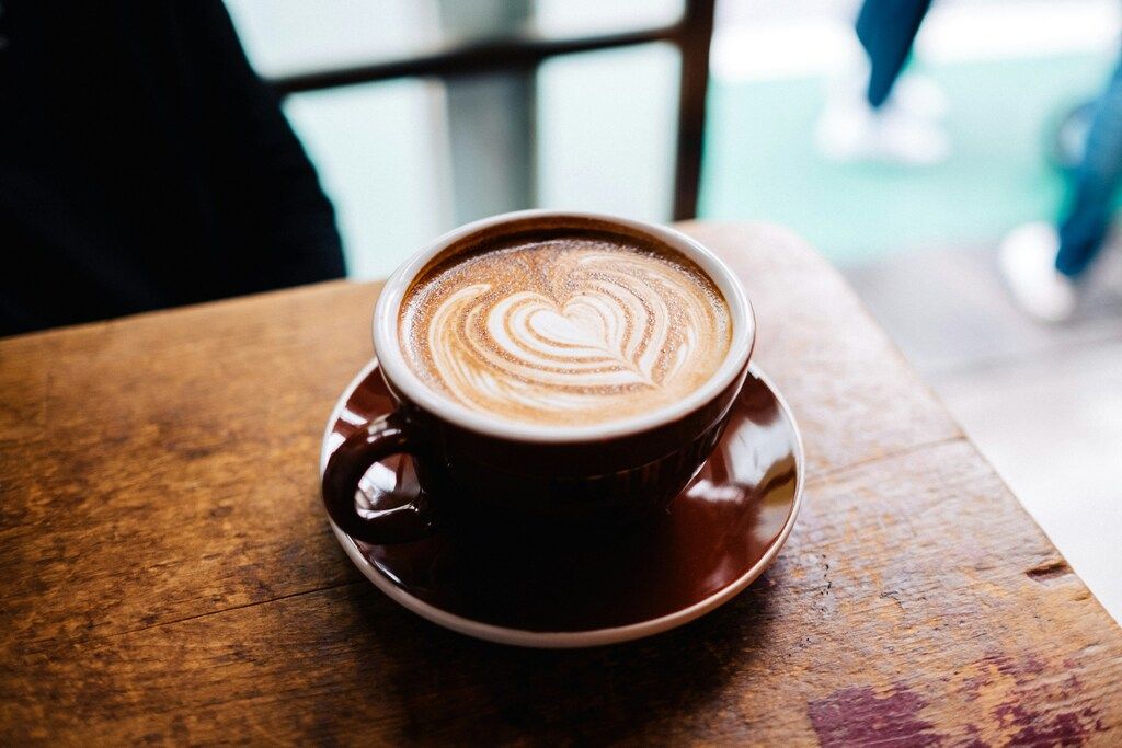 A cup of coffee with heart-shaped latte art, representing Iceland's strong coffee culture.