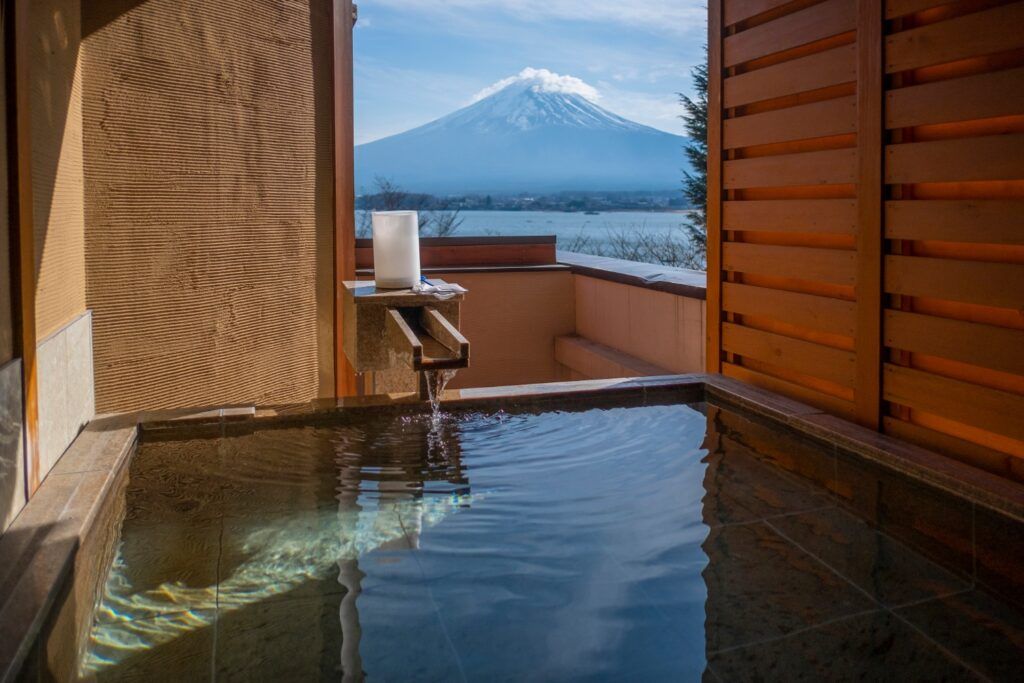 Indoor-outdoor onsen with a view of Mount Fuji and Lake Kawaguchiko.