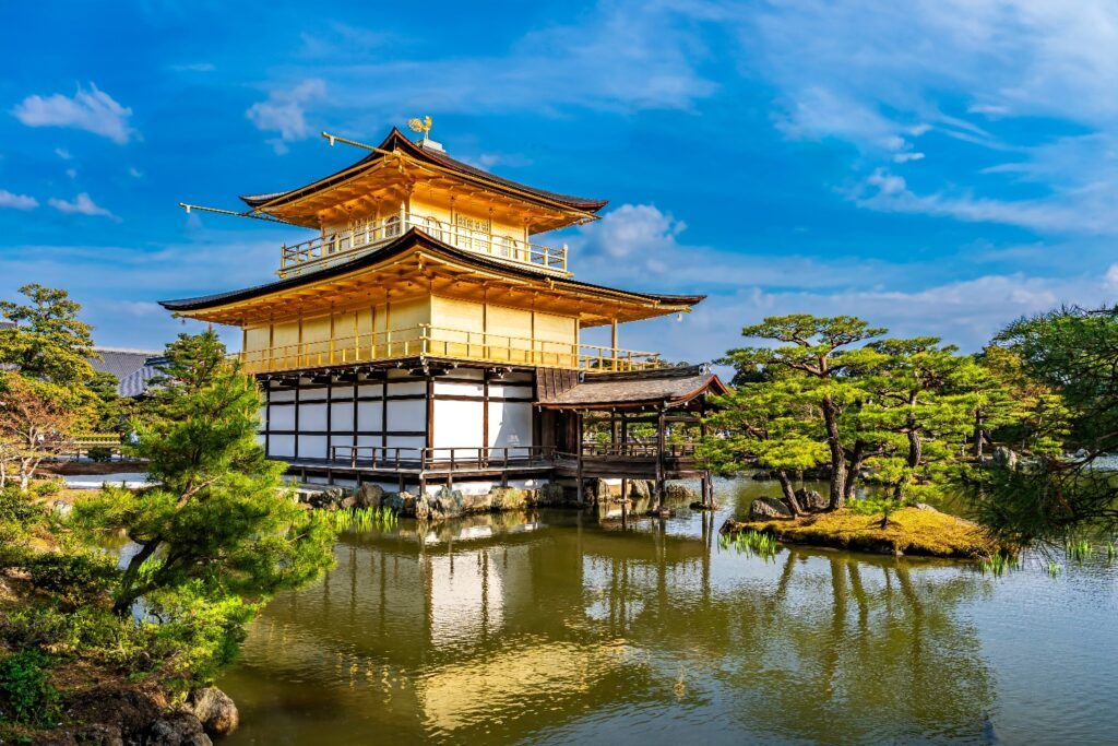 Kinkaku-ji Golden Pavilion reflected in its surrounding pond.