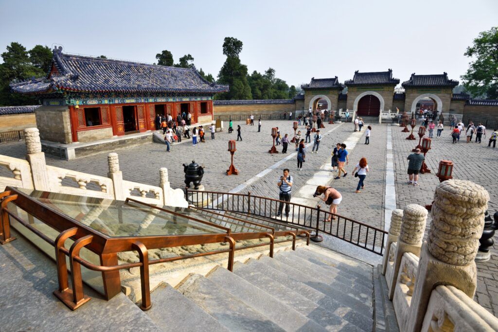 Courtyard of the Temple of Heaven with historic buildings and people.