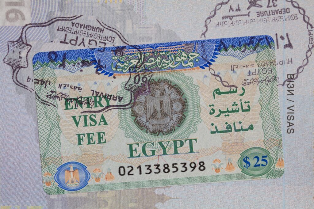 Close-up of an Egyptian entry visa and stamp inside a passport, showing the $25 fee.